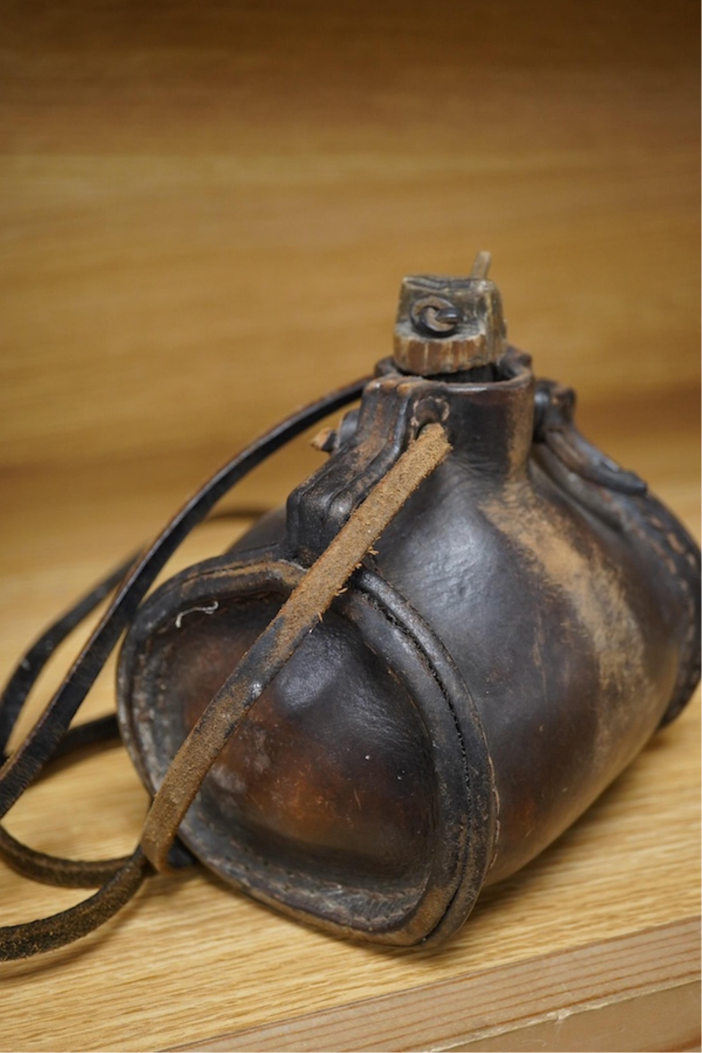 A leather cider costrel, 14cm wide. Condition - fair, some scuffing